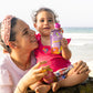 Loco Bebe Organic Caribbean Pumpkin Puree baby food pouch with toddler and mom at the beach smiling
